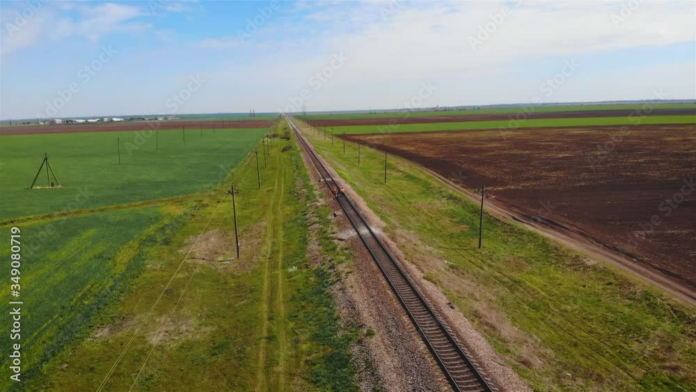 Railway workers in uniform walk along tracks and inspect condition of sleepers and rails. Maintenance of transport systems Railway workers in uniform walk along tracks and inspect condition of sleepers and rails. Maintenance of transport systems