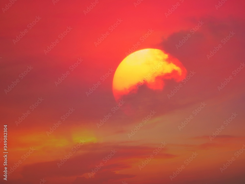 Beautiful big sunset over sea. Tranquil scene of Closeup red sun and red sky sunset over the ocean