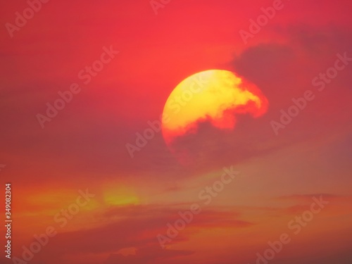 Beautiful big sunset over sea. Tranquil scene of Closeup red sun and red sky sunset over the ocean