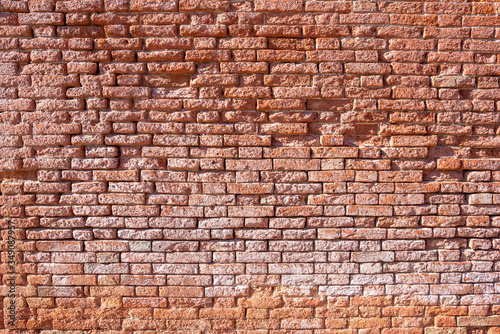 Pattern of a aged brick wall in venice, Italy.