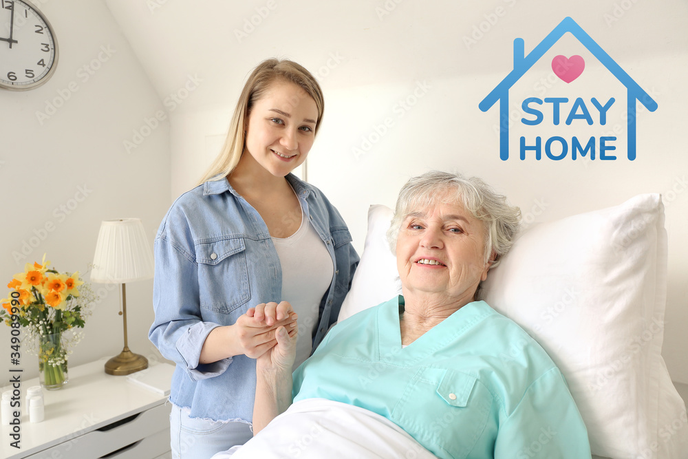 Obraz premium Young woman with her grandmother at home. Concept of coronavirus epidemic
