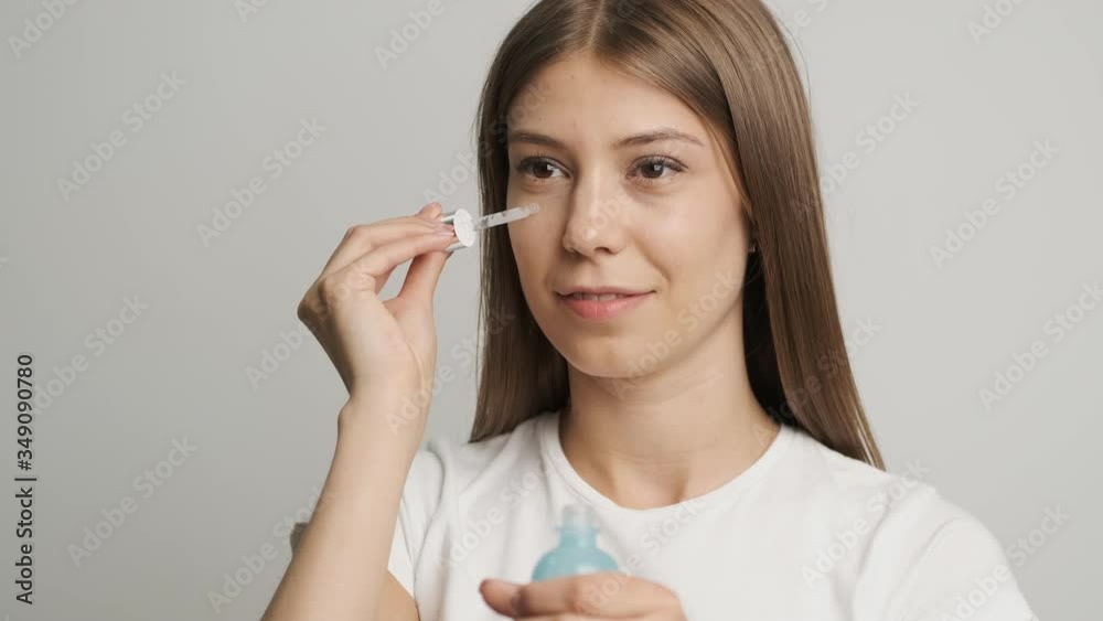 Cute girl of Caucasian appearance applies face cream Cute girl of Caucasian appearance applies face cream