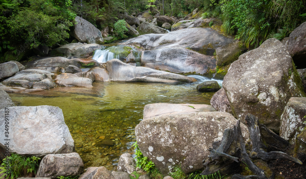 Tropical pool with cascades hidden in the jungle. Shot in Abel Tasman National Park, New Zealand