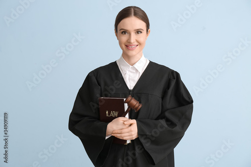 Female judge with book on light background photo