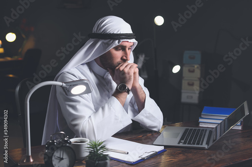 Arab businessman working in...