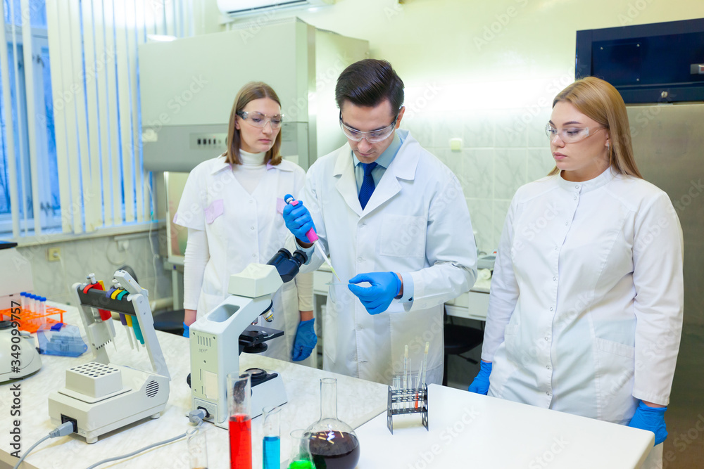 A group of scientists conducts research in a scientific laboratory using advanced technology. COVID-19. COVID Coronavirus A group of scientists conducts research in a scientific laboratory using advanced technology. COVID-19. COVID Coronavirus