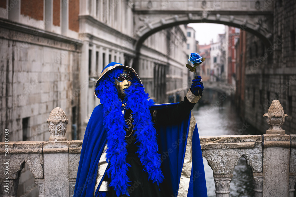 Portrait of a woman with a beautiful blue mask in Venice, Italy