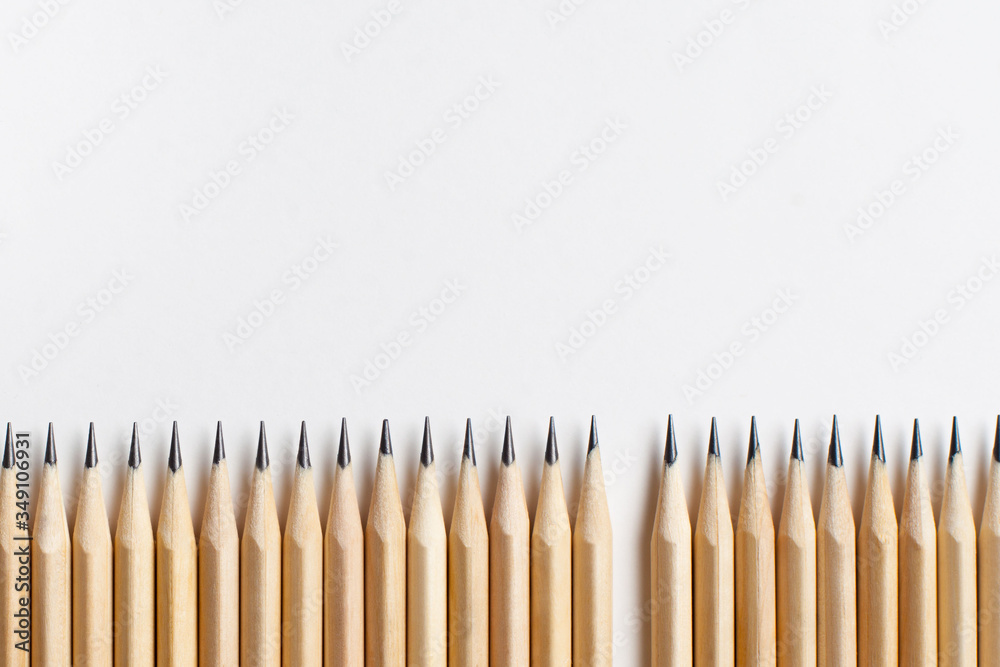 Neatly sharpened stationery pencils made of wood with one missing Neatly sharpened stationery pencils made of wood with one missing