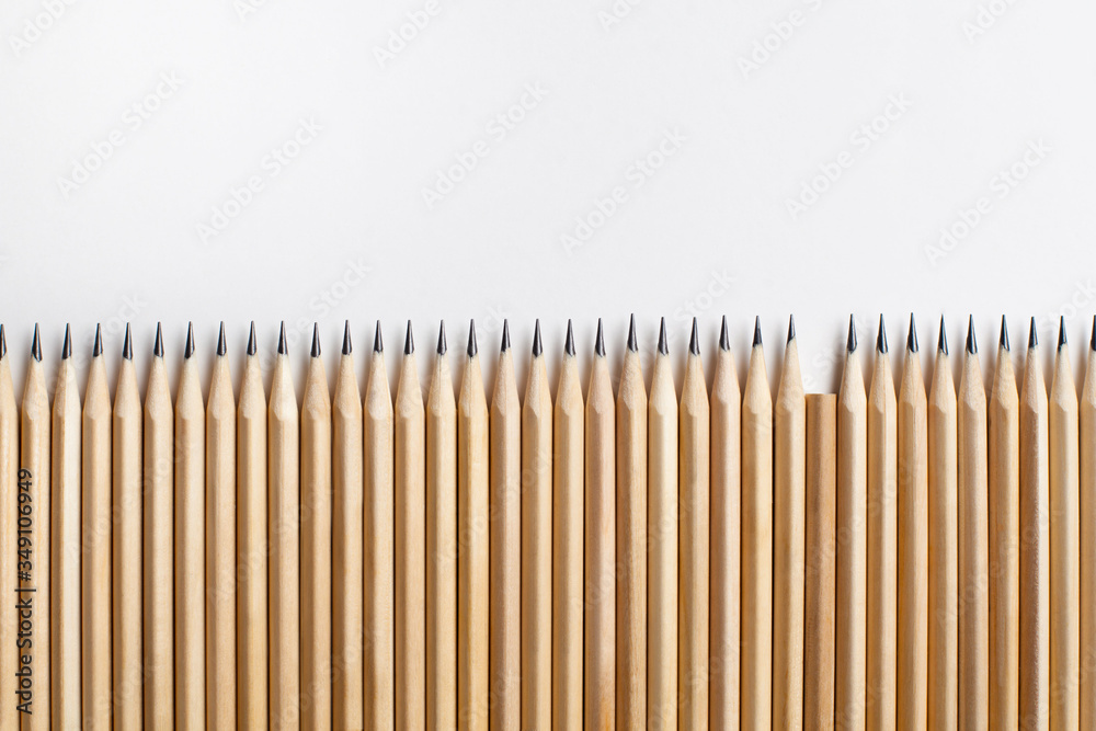 Neatly sharpened stationery pencils made of wood with one missing Neatly sharpened stationery pencils made of wood with one missing