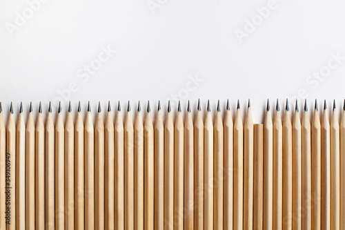 Neatly sharpened stationery pencils made of wood with one missing