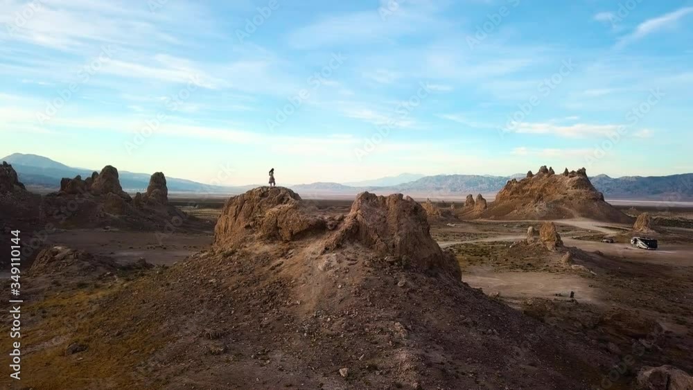 Woman standing on top of a mountain, looking into the distance. Woman standing on top of a mountain, looking into the distance.
