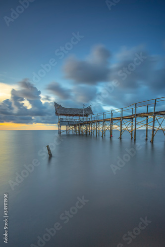 The beauty of the Mlandingan Situbondo wooden pier before sunset photo