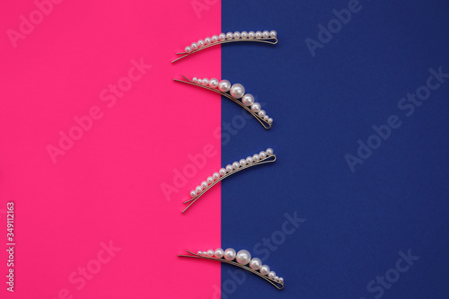 pearl hair clips. fashionable hair accessories. Hairpin with pearls on a combined bright pink and blue background.Hair decoration .Different hairpin clips set. © Yuliya