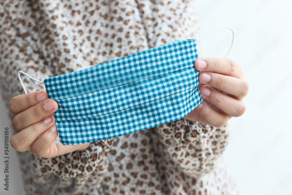 woman shows self-made mask to protect against viruses. woman shows self-made mask to protect against viruses.