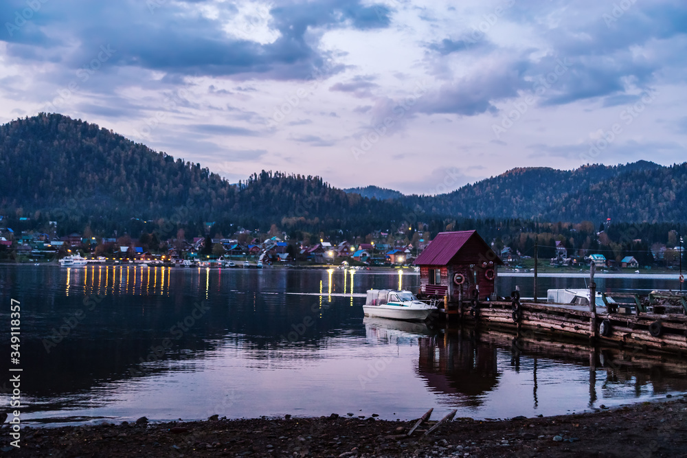 Lake wharf with a wooden pier at dawn. Teletskoye Lake, Artybash Village, Altai Republic, Russia