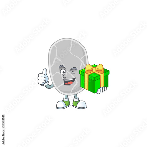 Happy smiley nitrospirae cartoon mascot design with a gift box