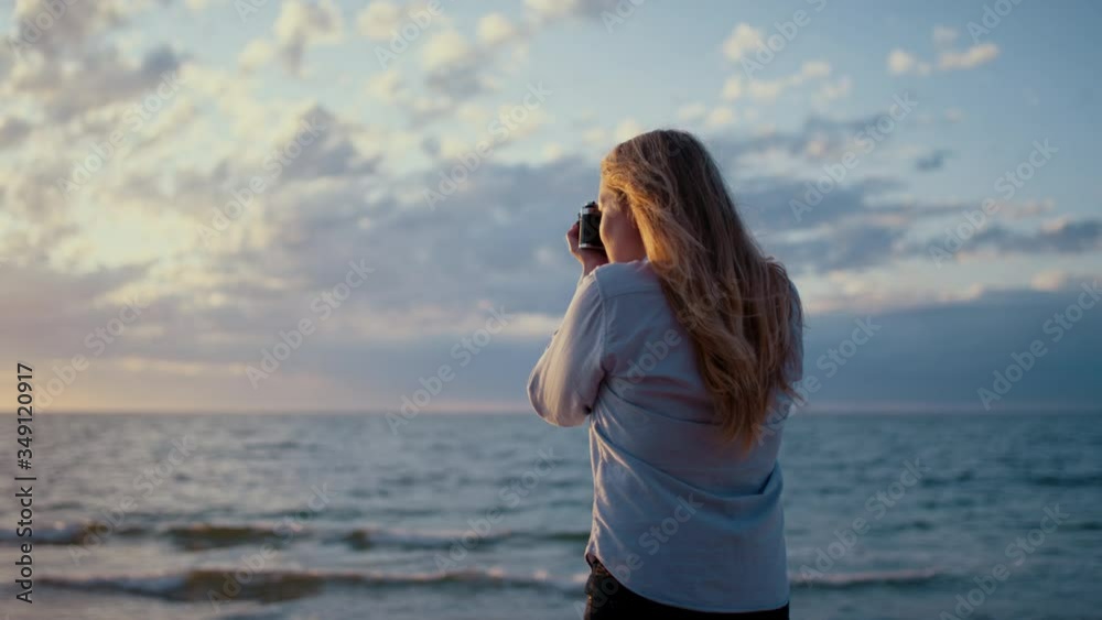 Blonde Woman Photographer Taking Photos of the Ocean. Blonde Woman Photographer Taking Photos of the Ocean.