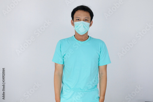 Young Asian boy wearing protective mask against the corona virus covid 19 brown man wearing surgical mask to prevent from virus white background. Corona virus pandemic