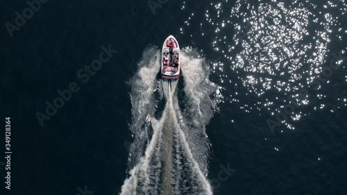 Boat Ride With A Wakeboarder On The Blue Sea In Sherbrooke, Quebec, Canada - Extreme Travel Adventure - aerial shot photo