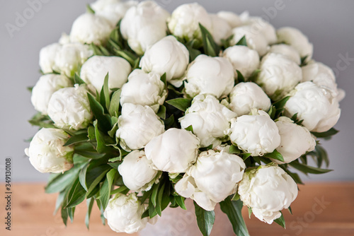 Fototapeta Naklejka Na Ścianę i Meble -  White Madame Claude Tain peonies in a metal vase. Beautiful peony flower for catalog or online store. Floral shop concept . Beautiful fresh cut bouquet. Flowers delivery