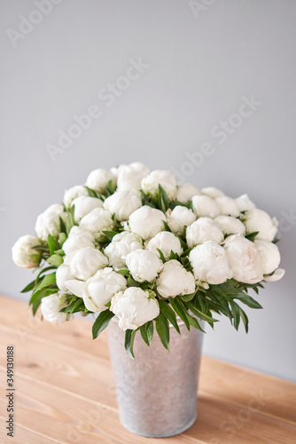 Fototapeta Naklejka Na Ścianę i Meble -  White Madame Claude Tain peonies in a metal vase. Beautiful peony flower for catalog or online store. Floral shop concept . Beautiful fresh cut bouquet. Flowers delivery