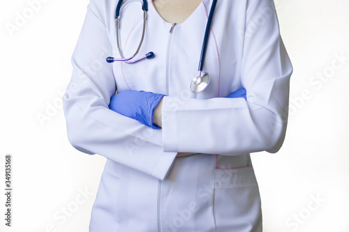 Cropped closeup photo of professional doctor in gloves standing with folded crossed arms