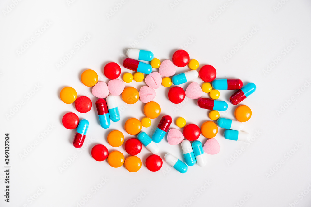 A lot of pills colorful on the white background. Medicine pills, tablets and capsules.