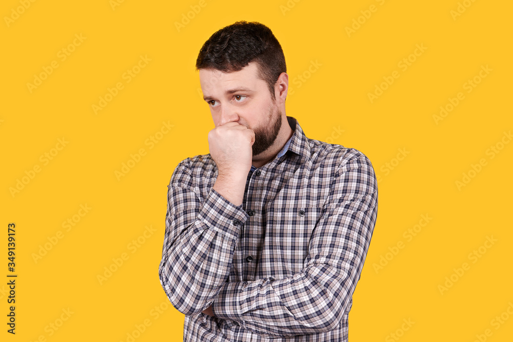 Man with beard holding his head with hand, panic, isolated on orange background. Man with beard holding his head with hand, panic, isolated on orange background.
