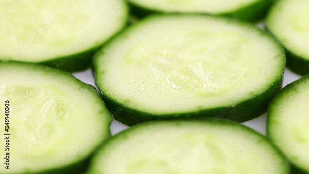 Cucumber sliced green slices rotate, spinning slowly in a circle, close up. Cucumber sliced green slices rotate, spinning slowly in a circle, close up.