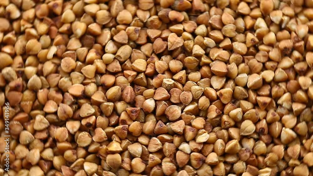 Buckwheat raw bulk rotate, top view, spinning slowly in a circle, close up. Buckwheat raw bulk rotate, top view, spinning slowly in a circle, close up.