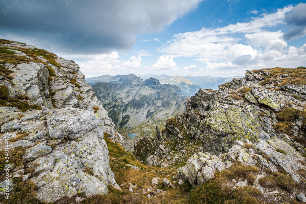 Beautiful mountain scenery - A small mountain lake and rocky mountains. Beautiful landscapes. Rila mountain, Bulgaria. Trekking / hiking concept.