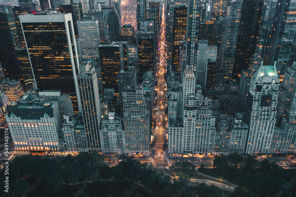 Dramatic View of Dark Epic Manhattan, New York City Avenue right after Sunset with City Lights - obrazy, fototapety, plakaty 