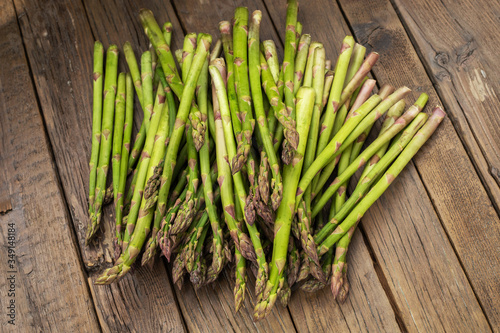 Bunch of fresh green asparagus spears on a rustic wooden table