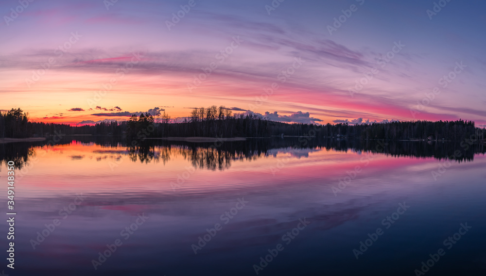 Fototapeta premium Scenic lake landscape with tranquility mood, sunset and beautiful reflections at spring evening in Finland