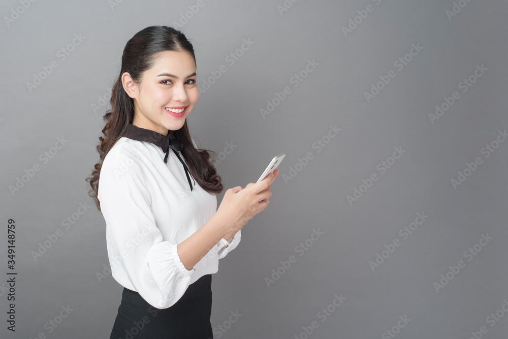 Portrait of Beautiful Business woman is using cellphone in studio Portrait of Beautiful Business woman is using cellphone in studio