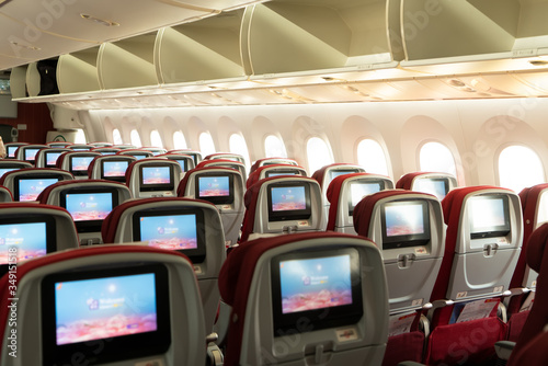 Seats and windows in aircraft cabin..