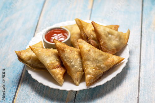 Asian food. Samsa  samosas  with chicken fillet and cheese on wooden background