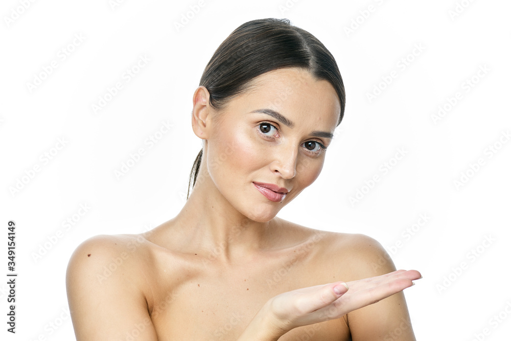 Photo of happy young woman standing isolated over white wall background. Looking camera showing copyspace pointing. Photo of happy young woman standing isolated over white wall background. Looking camera showing copyspace pointing.