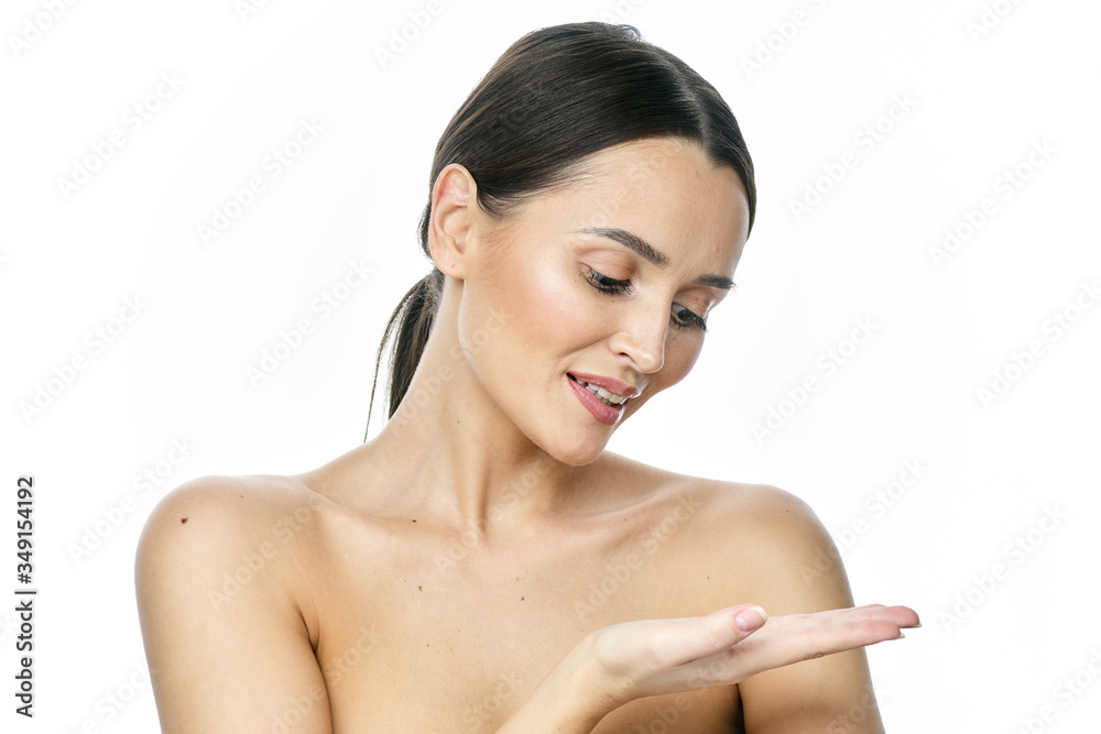 Photo of happy young woman standing isolated over white wall background. Looking camera showing copyspace pointing. Photo of happy young woman standing isolated over white wall background. Looking camera showing copyspace pointing.