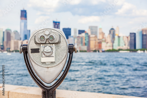 New York City tourism travel background tourist icon - coin operated binocular tower viewer with skyline view in summer. USA destination.