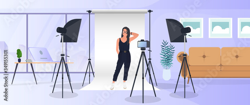 Photo Studio Vector. Girl posing to the camera. White canvas background on tripods. Camera on a tripod, softbox. Professional photo studio.