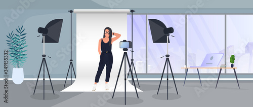 Photo Studio Vector. Girl posing to the camera. White canvas background on tripods. Camera on a tripod, softbox. Professional photo studio.