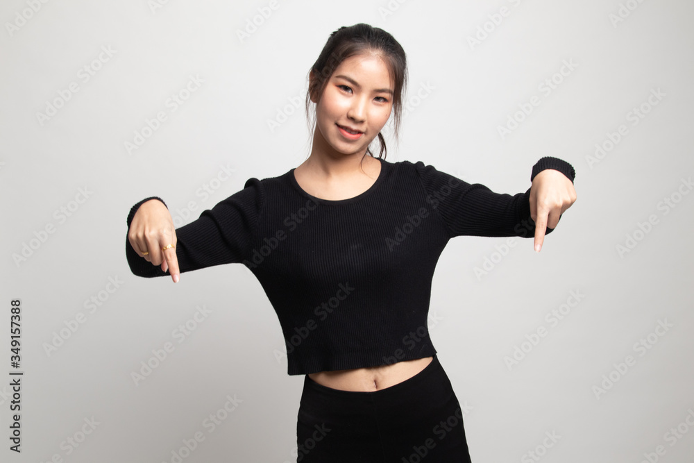 Beautiful young Asian woman point down to blank space. Beautiful young Asian woman point down to blank space.
