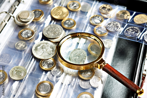 Numismatic coins with magnifying glass photo