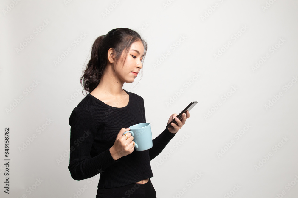 Young Asian woman with mobile phone and coffee cup. Young Asian woman with mobile phone and coffee cup.