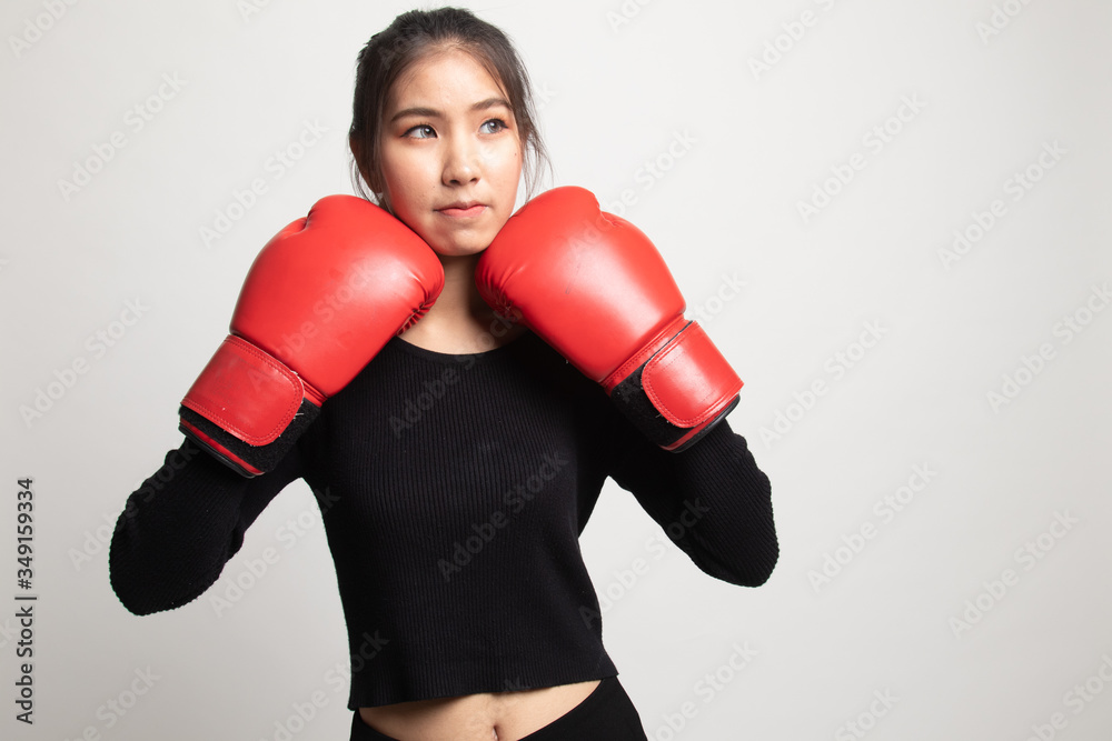 Young Asian woman with red boxing gloves. Young Asian woman with red boxing gloves.