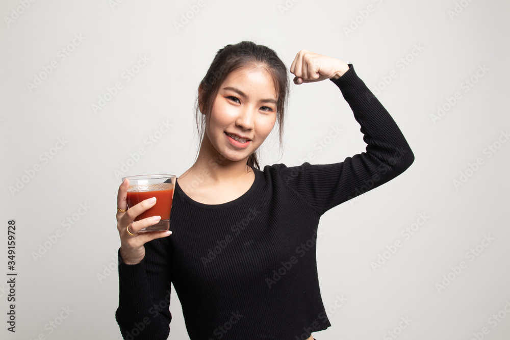 Strong healthy Asian woman with tomato juice. Strong healthy Asian woman with tomato juice.