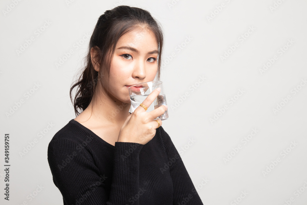 Young Asian woman with a glass of drinking water. Young Asian woman with a glass of drinking water.