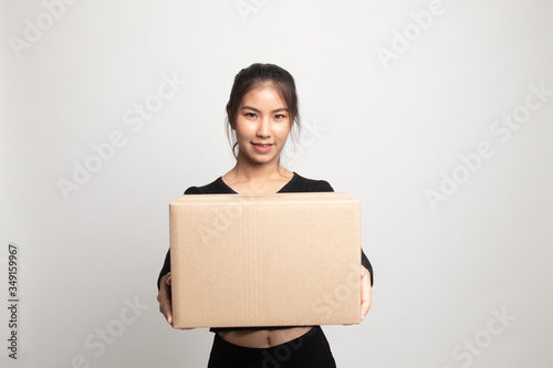 Delivery, relocation and unpacking. young asian woman holding cardboard box.