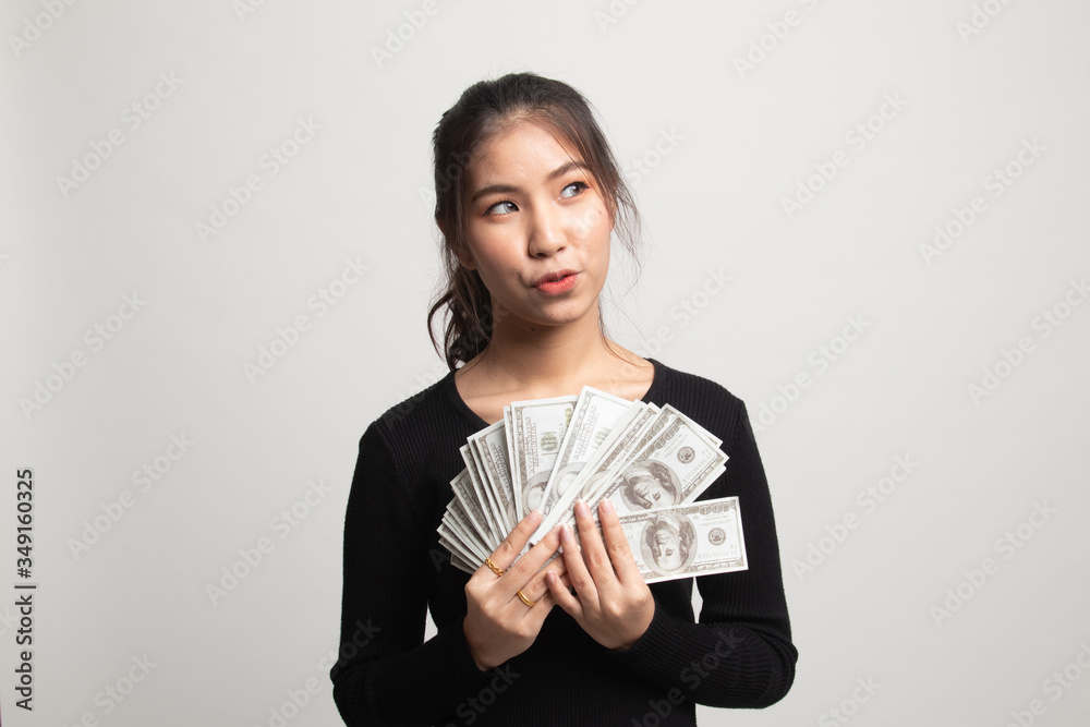Portrait of young asian woman showing bunch of money banknotes. Portrait of young asian woman showing bunch of money banknotes.